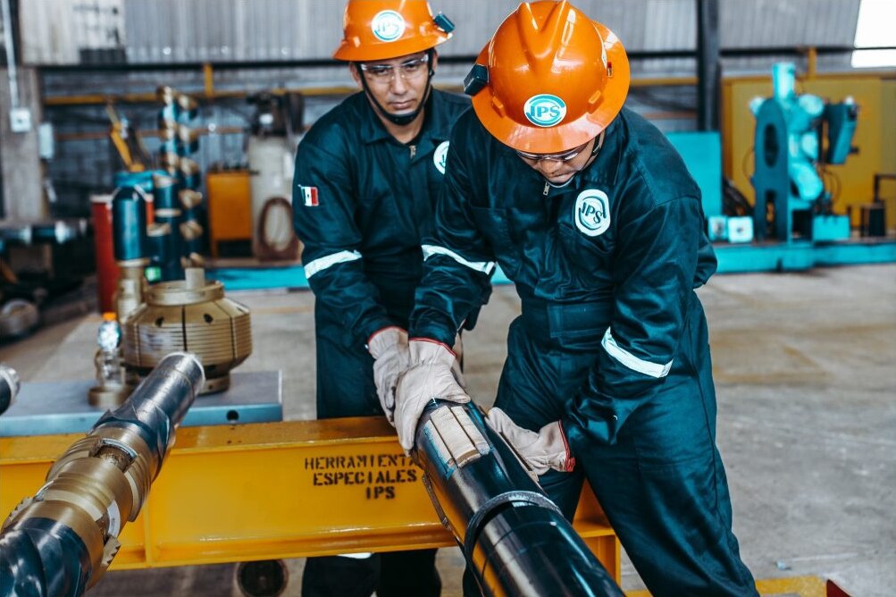 Technicians assembling a liner hanger in the workshop