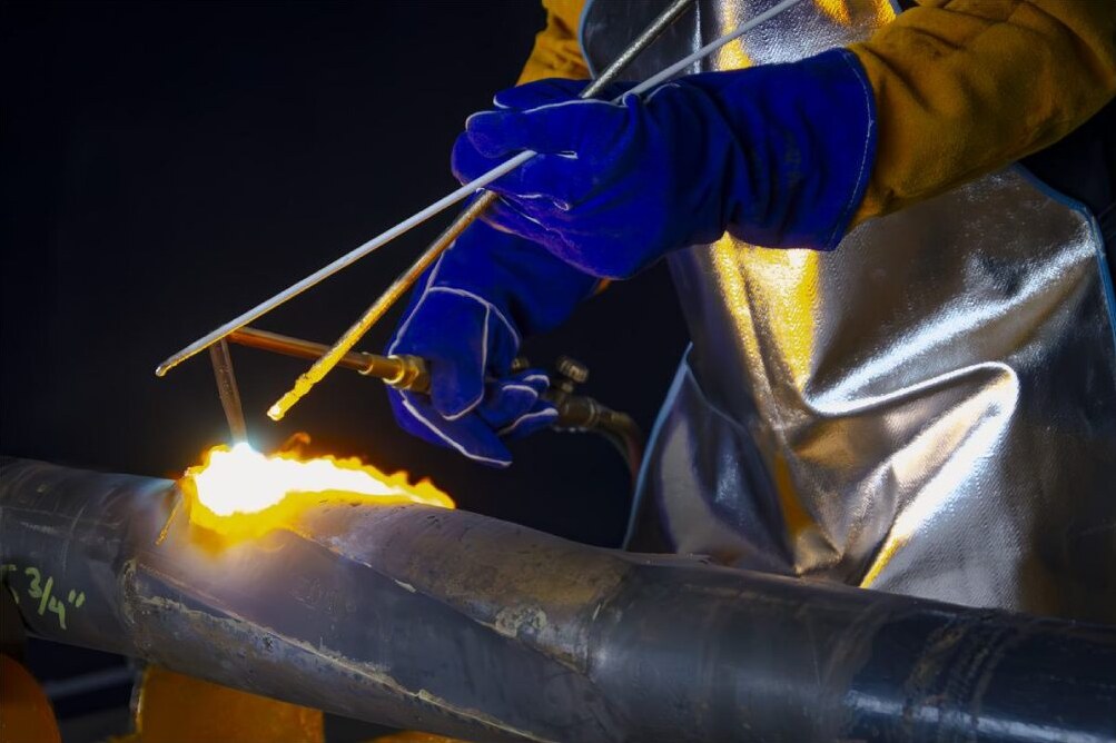 Torch cutting a section of pipe