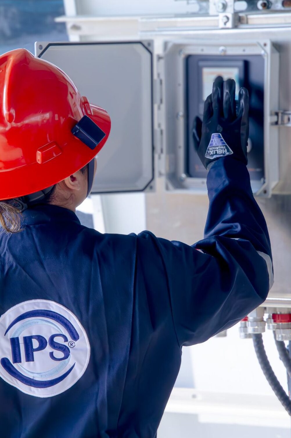 Technician checking a well testing control panel