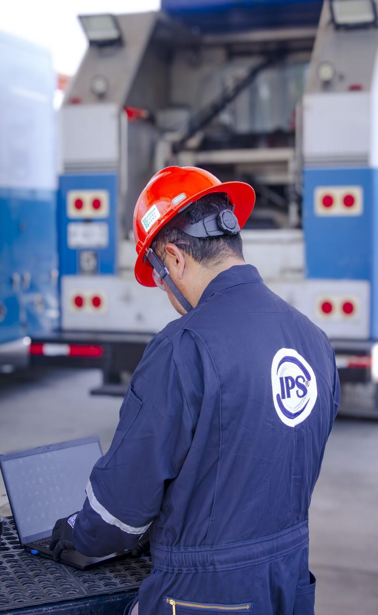Engineer reviewing data on a laptop beside a testing unit