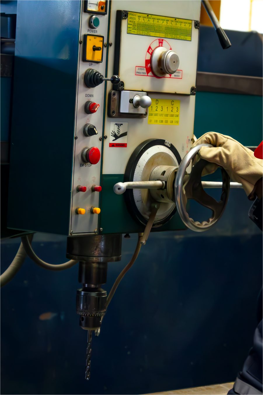 Operator at the controls of a drill press