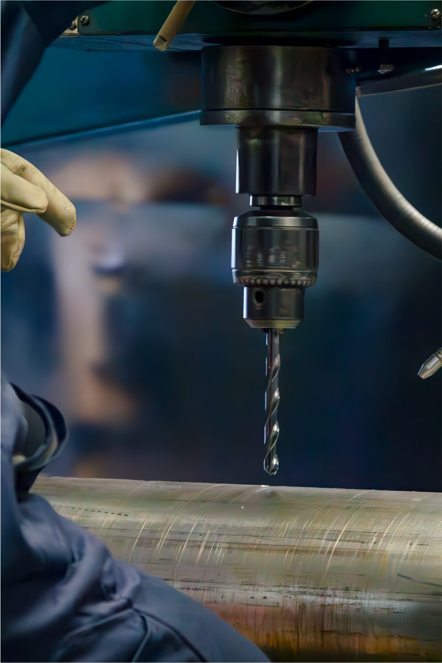 Drill bit cutting into a steel pipe