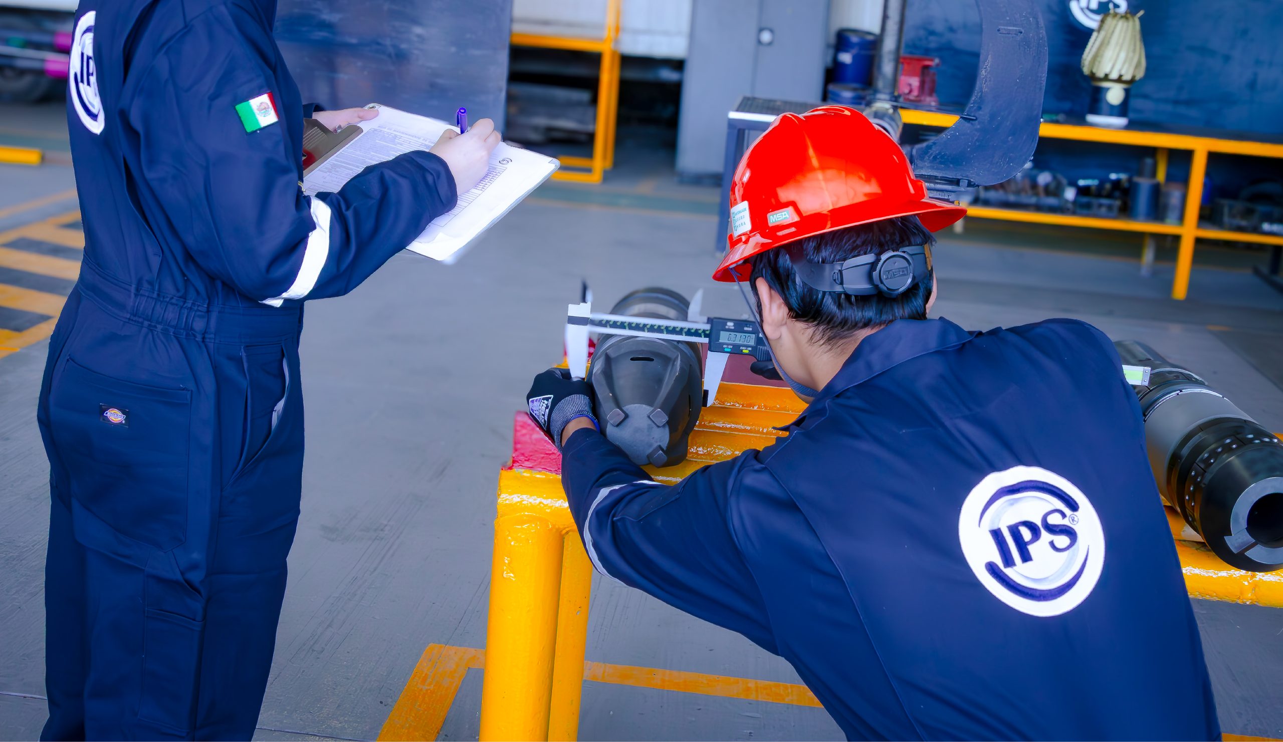 Technician measuring a tool with a caliper in the workshop