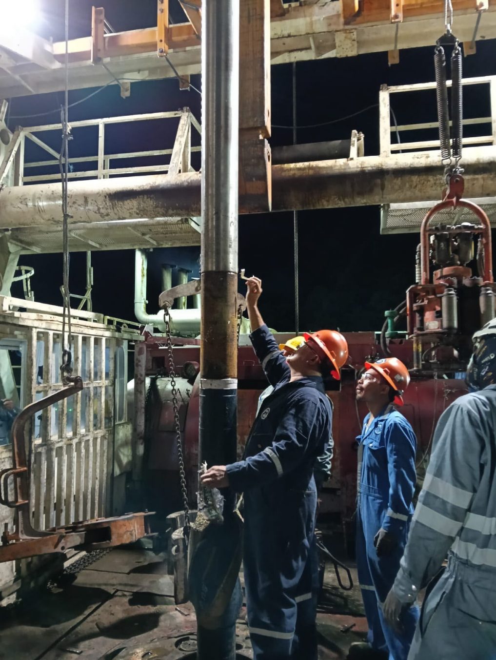 Field crew working on the drill floor of a geothermal rig