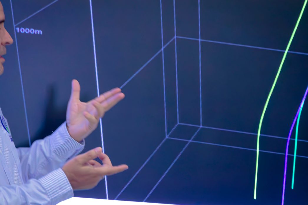 Engineer pointing at a three-dimensional reservoir model