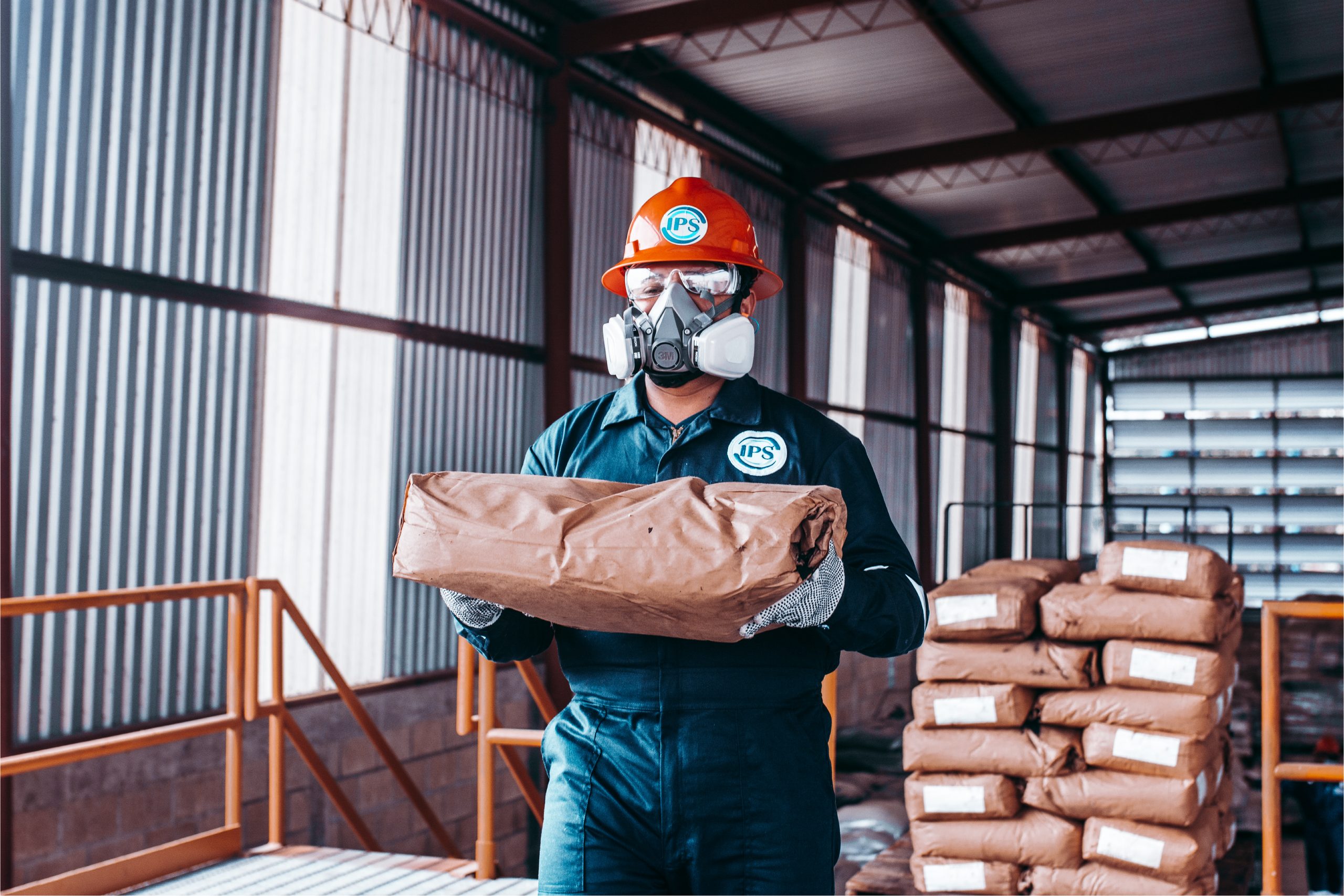 Technician carrying a sack of diverting agent in the warehouse