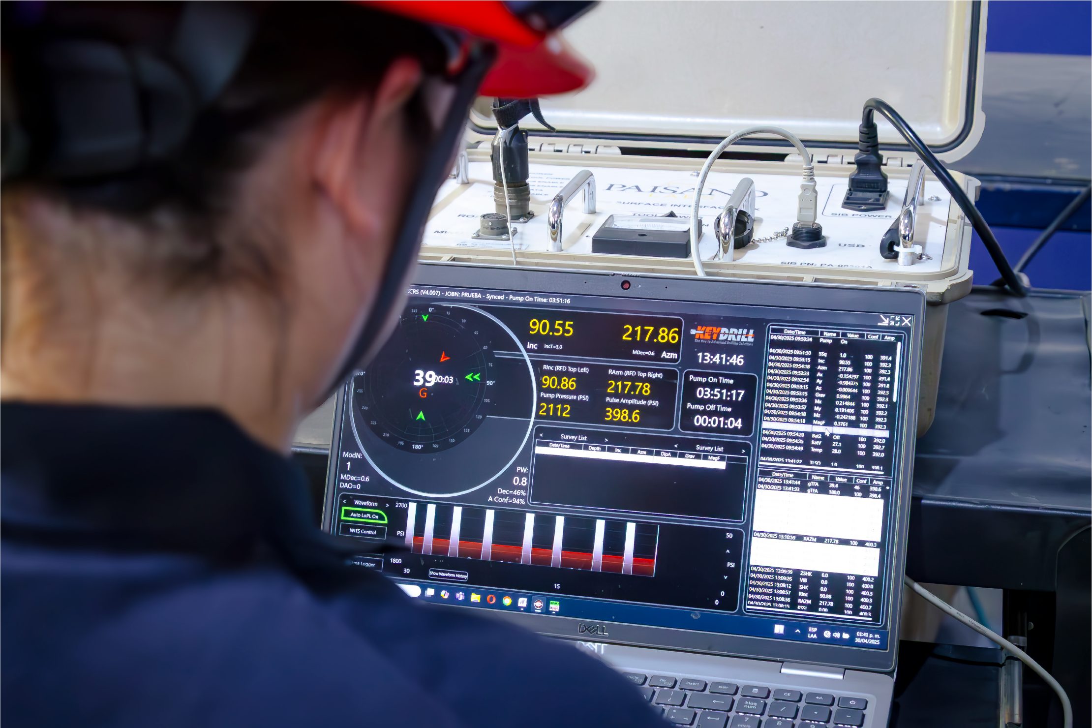 Engineer reviewing logging data on a field laptop